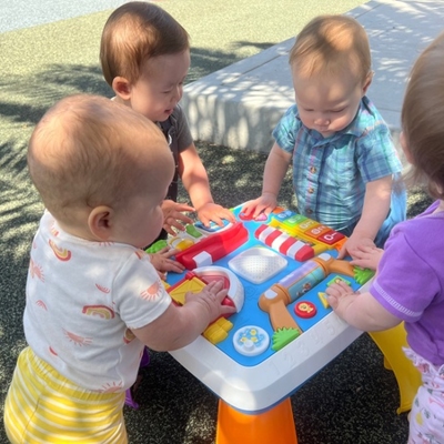 Children playing on an activity table Photo
